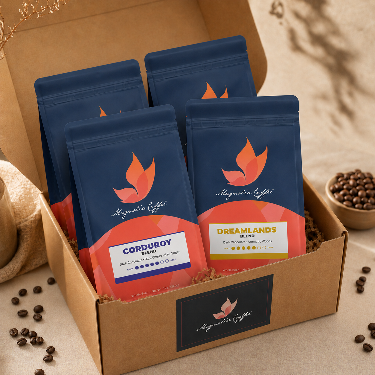 Box of 4 Magnolia Coffee packages with dark roast coffee beans around