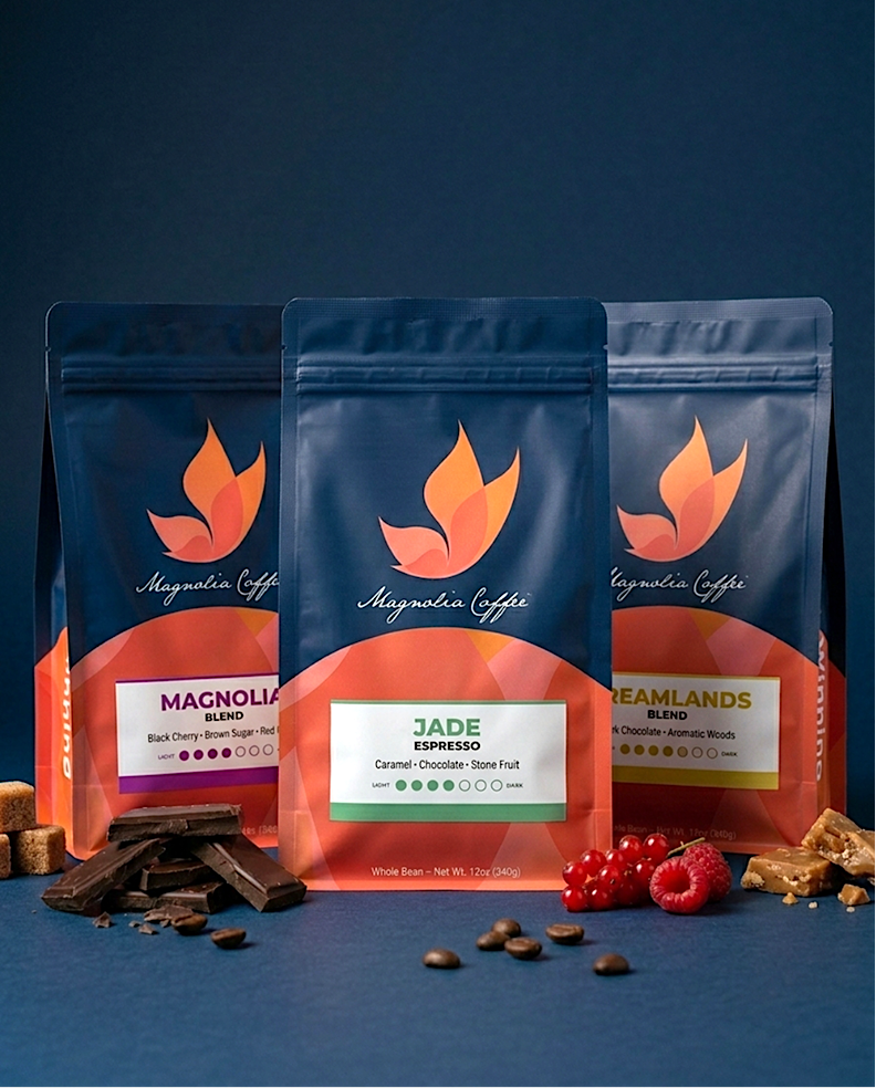 Three Magnolia Coffee bags with different blends on a blue background